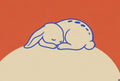 Bunny asleep on a cream boulder, persimmon orange behind. Animal art print by Drunk Dame.