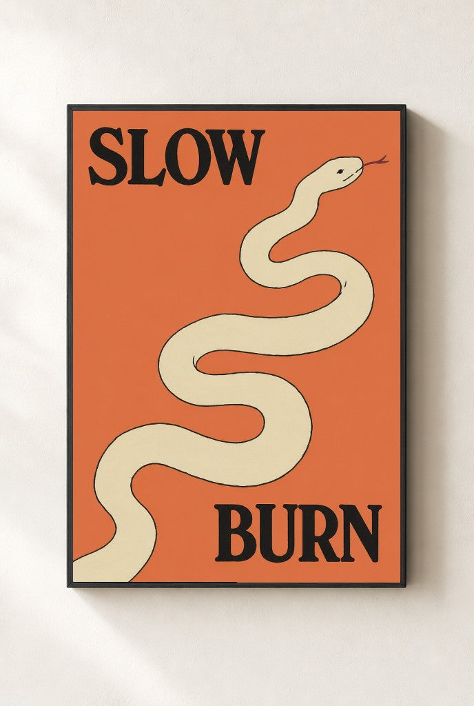 Slow Burn print, mounted in a black wood frame on a cream wall.