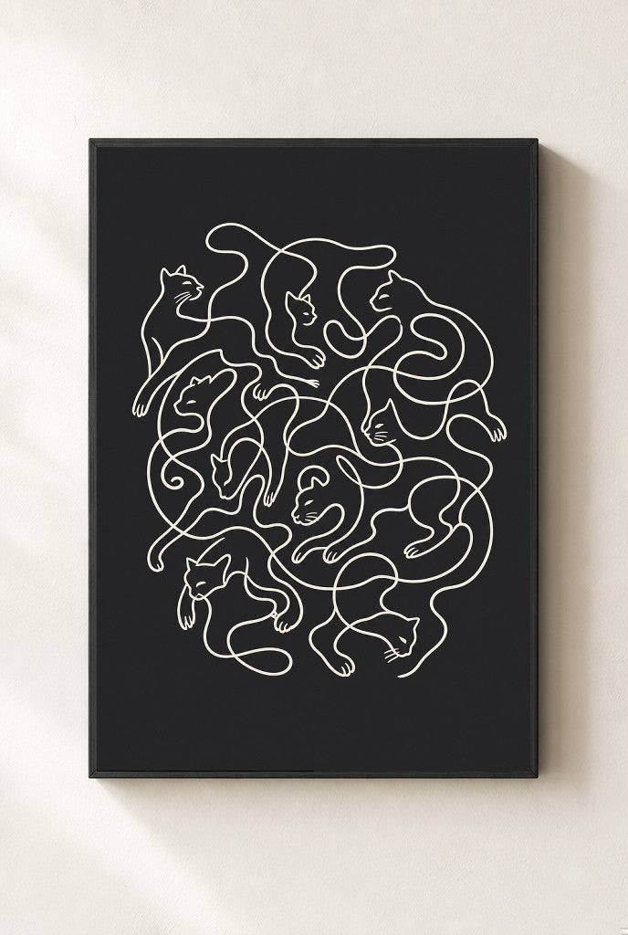 Tangled Cats print, mounted in a black wood frame on a cream wall.