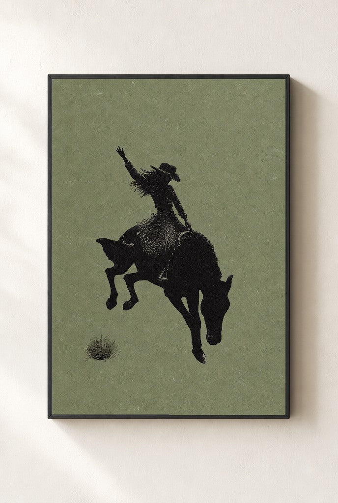 Bronc Rider, Sage print, mounted in a black wood frame on a cream wall.