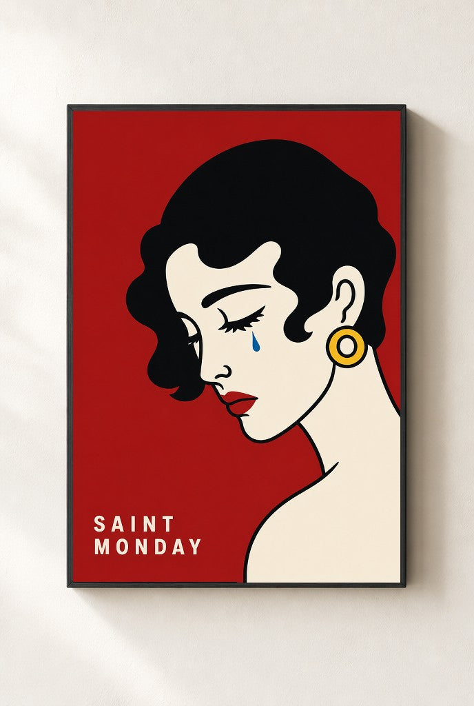 Saint Monday print, mounted in a black wood frame on a cream wall.