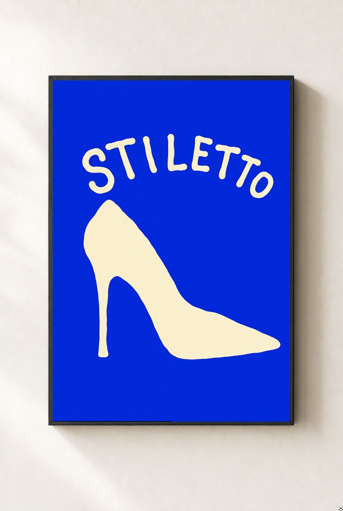 Stiletto print, mounted in a black wood frame on a cream wall.