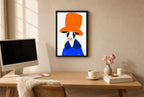 Framed Big Hat Energy hung above a mid-century walnut console with ceramics.