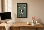 Framed Pour Cow hung above a mid-century walnut console with ceramics.