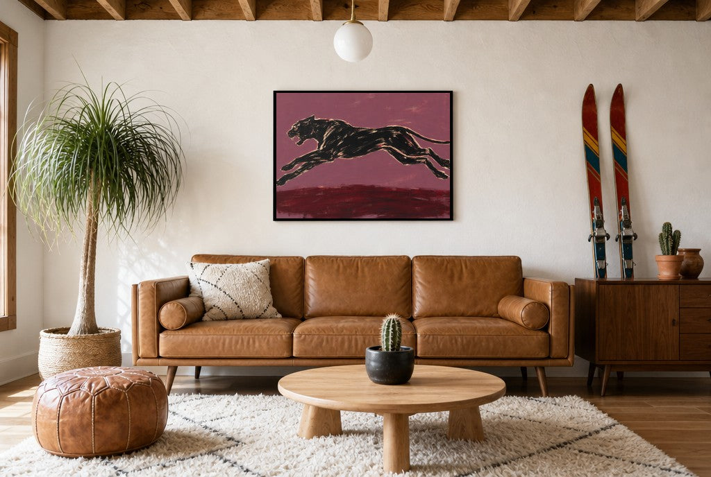 Framed Black Panther, Plum hung above a mid-century walnut console with ceramics.