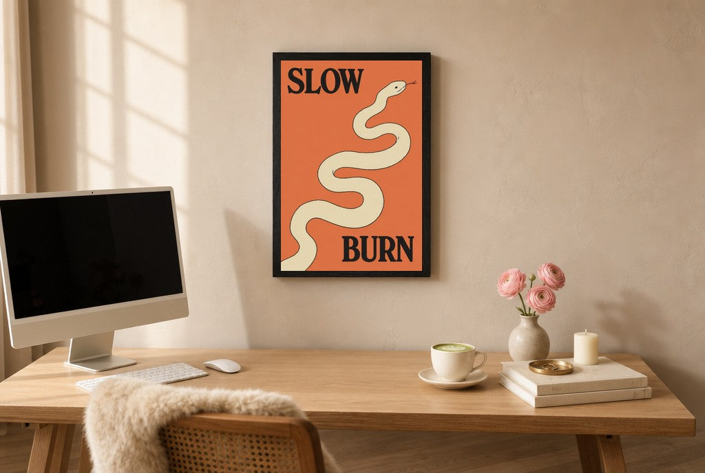 Framed Slow Burn hung above a mid-century walnut console with ceramics.