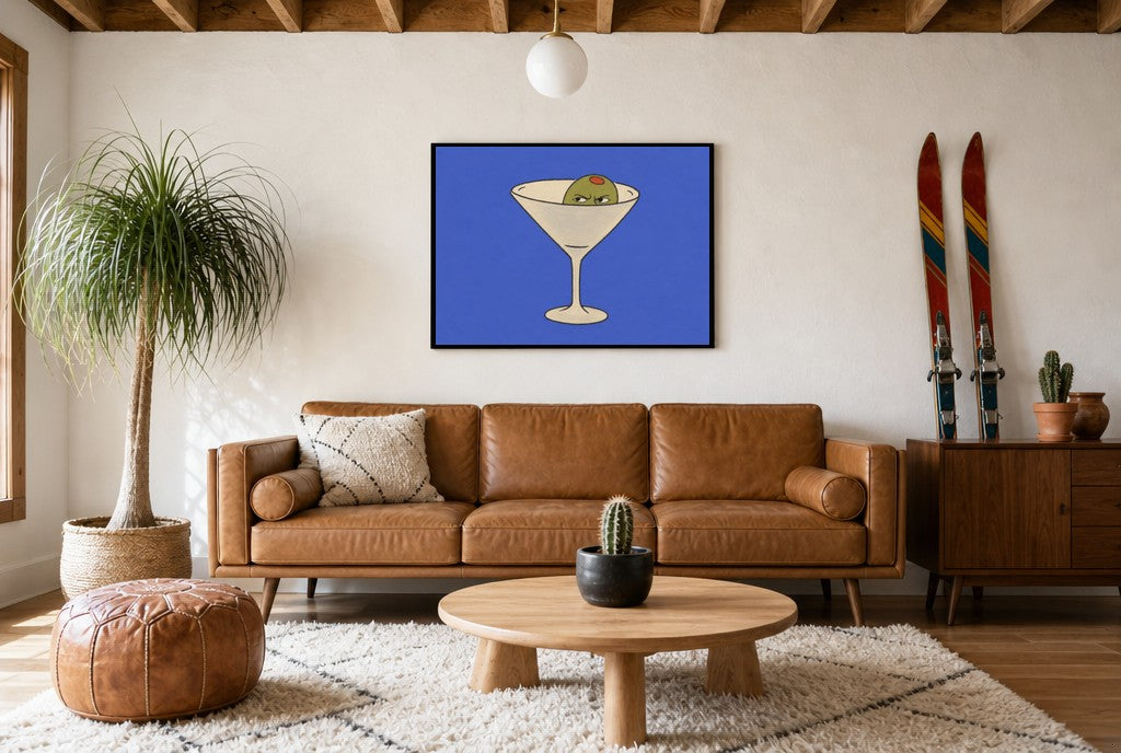 Framed Angry Olive, Martini hung above a mid-century walnut console with ceramics.