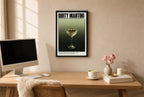 Framed Dirty Martini hung above a mid-century walnut console with ceramics.