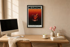 Framed Negroni hung above a mid-century walnut console with ceramics.