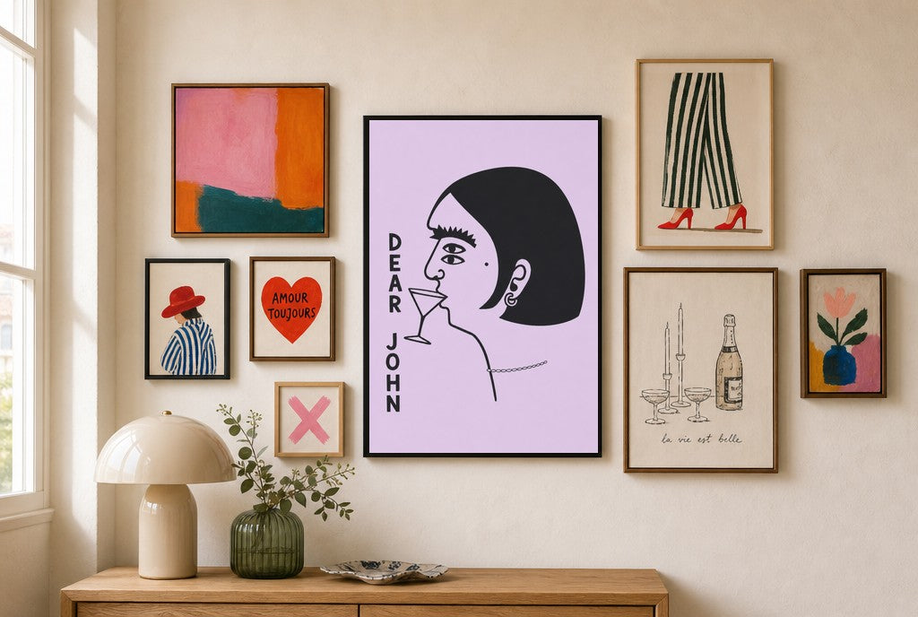 Dear John mixed into a layered gallery wall of varied frame sizes.