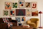 Two Greyhounds, Oxblood mixed into a layered gallery wall of varied frame sizes.