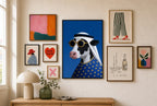 Yellow, Round Two mixed into a layered gallery wall of varied frame sizes.