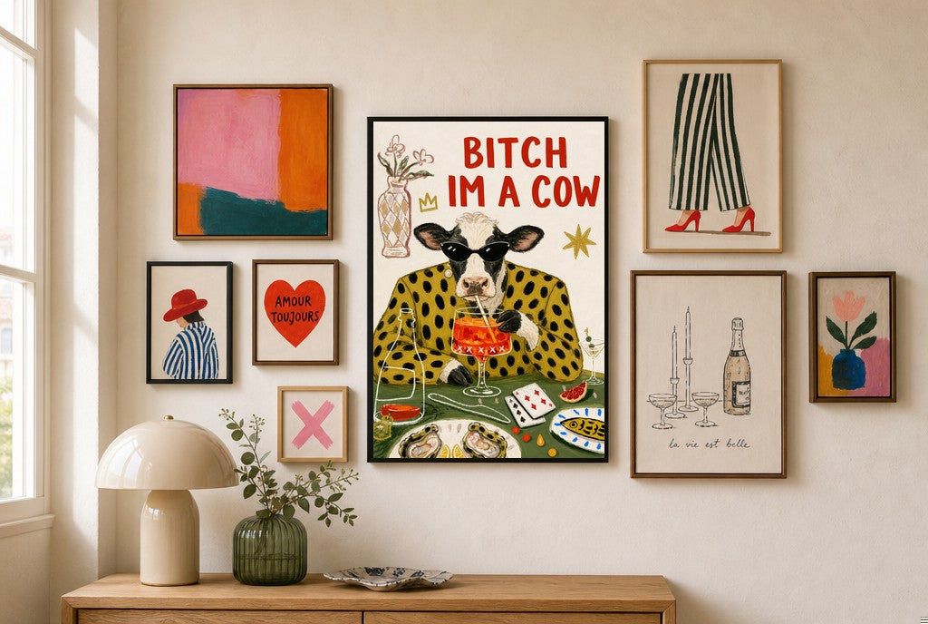 Bitch I'm a Cow mixed into a layered gallery wall of varied frame sizes.