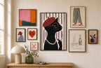 Cat, Red Beret mixed into a layered gallery wall of varied frame sizes.