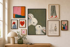 Two Rabbits, Olive mixed into a layered gallery wall of varied frame sizes.