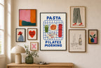 Pasta Pilates Morning mixed into a layered gallery wall of varied frame sizes.