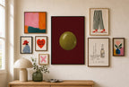 One Olive, Oxblood mixed into a layered gallery wall of varied frame sizes.
