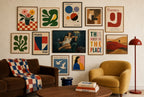 Wine Chair, Lamp mixed into a layered gallery wall of varied frame sizes.