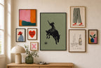 Bronc Rider, Sage mixed into a layered gallery wall of varied frame sizes.
