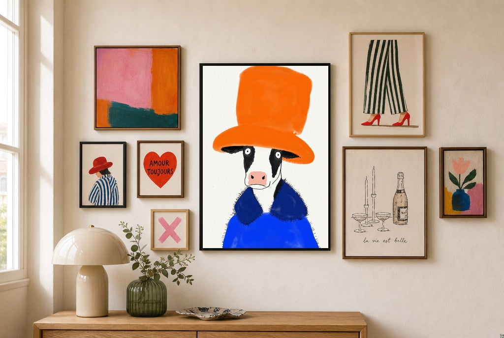 Big Hat Energy mixed into a layered gallery wall of varied frame sizes.