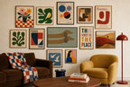 Two Dachshunds, Sage mixed into a layered gallery wall of varied frame sizes.