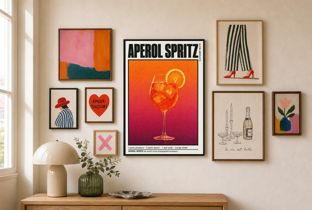 Aperol Spritz mixed into a layered gallery wall of varied frame sizes.