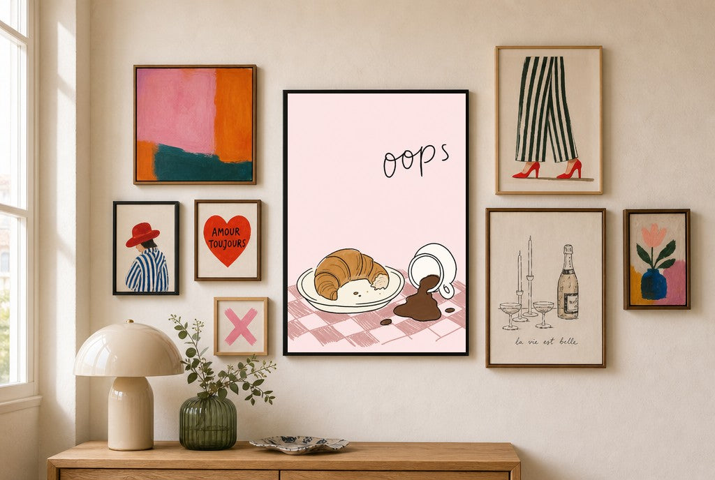 Oops, Croissant mixed into a layered gallery wall of varied frame sizes.