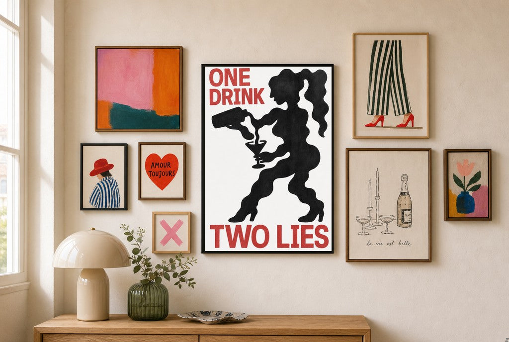 One Drink, Two Lies mixed into a layered gallery wall of varied frame sizes.