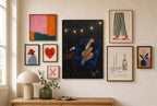 Tux, Vinyl, Cobalt mixed into a layered gallery wall of varied frame sizes.