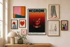Negroni mixed into a layered gallery wall of varied frame sizes.