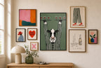 Pour Cow mixed into a layered gallery wall of varied frame sizes.