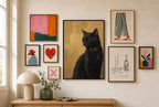 Black Cat, Red Bow mixed into a layered gallery wall of varied frame sizes.