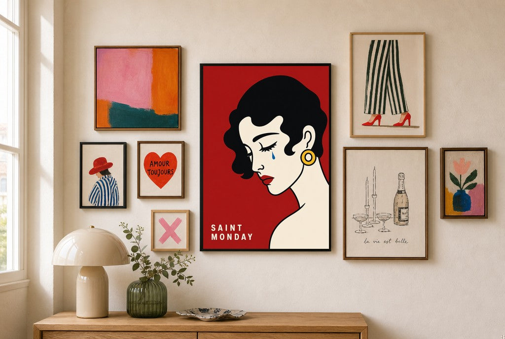 Saint Monday mixed into a layered gallery wall of varied frame sizes.