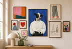 Calm in a White Sweater mixed into a layered gallery wall of varied frame sizes.