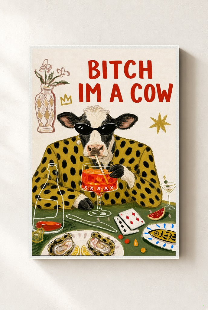 Bitch I'm a Cow print, mounted in a white wood frame on a cream wall.