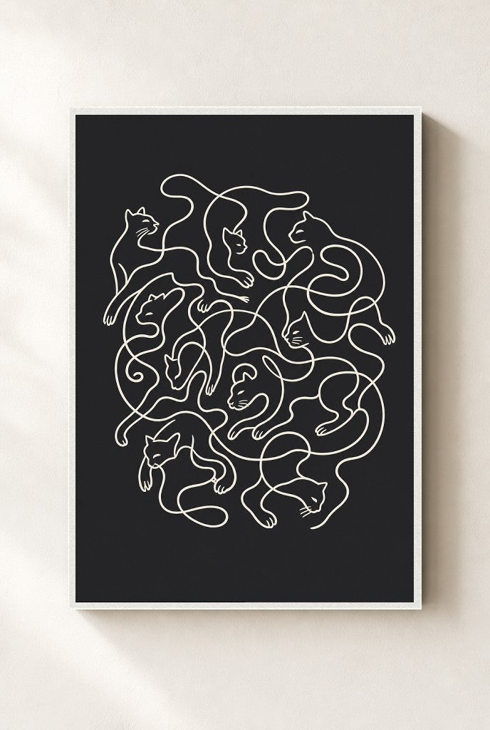 Tangled Cats print, mounted in a white wood frame on a cream wall.