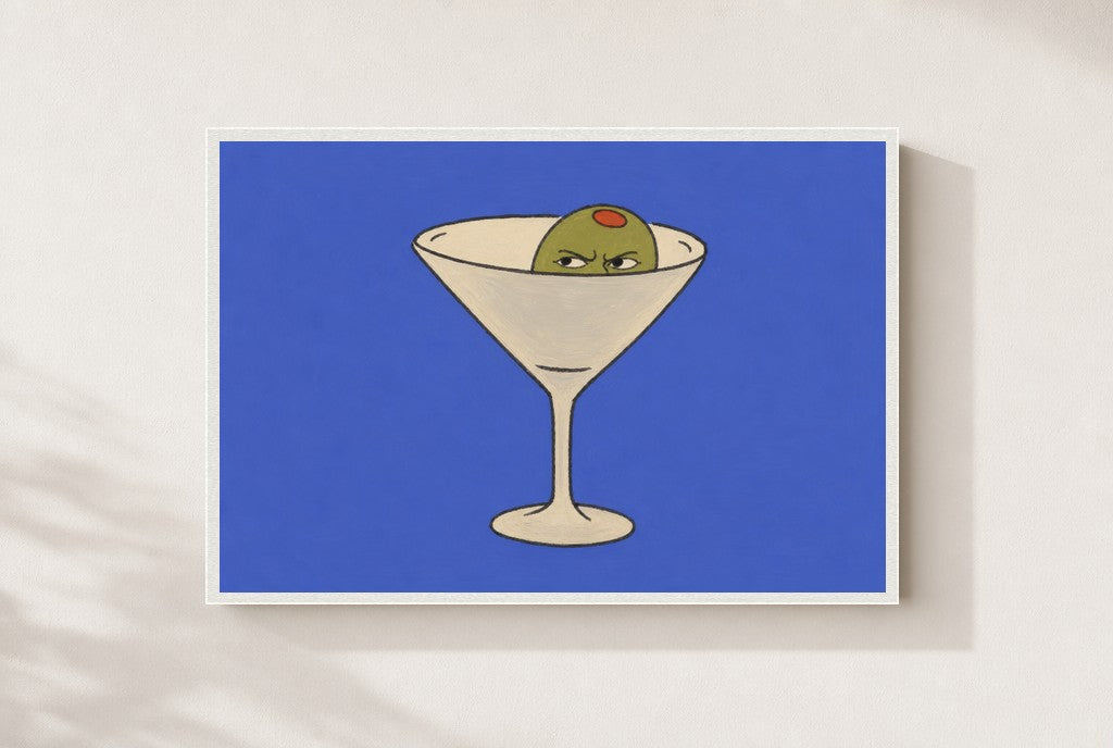 Angry Olive, Martini print, mounted in a white wood frame on a cream wall.
