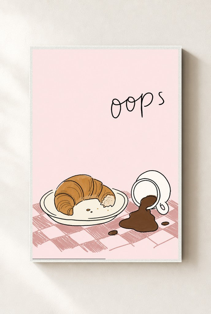 Oops, Croissant print, mounted in a white wood frame on a cream wall.