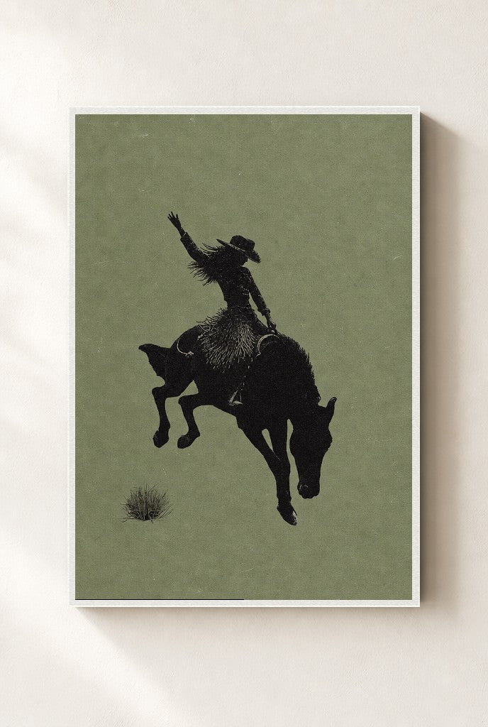 Bronc Rider, Sage print, mounted in a white wood frame on a cream wall.