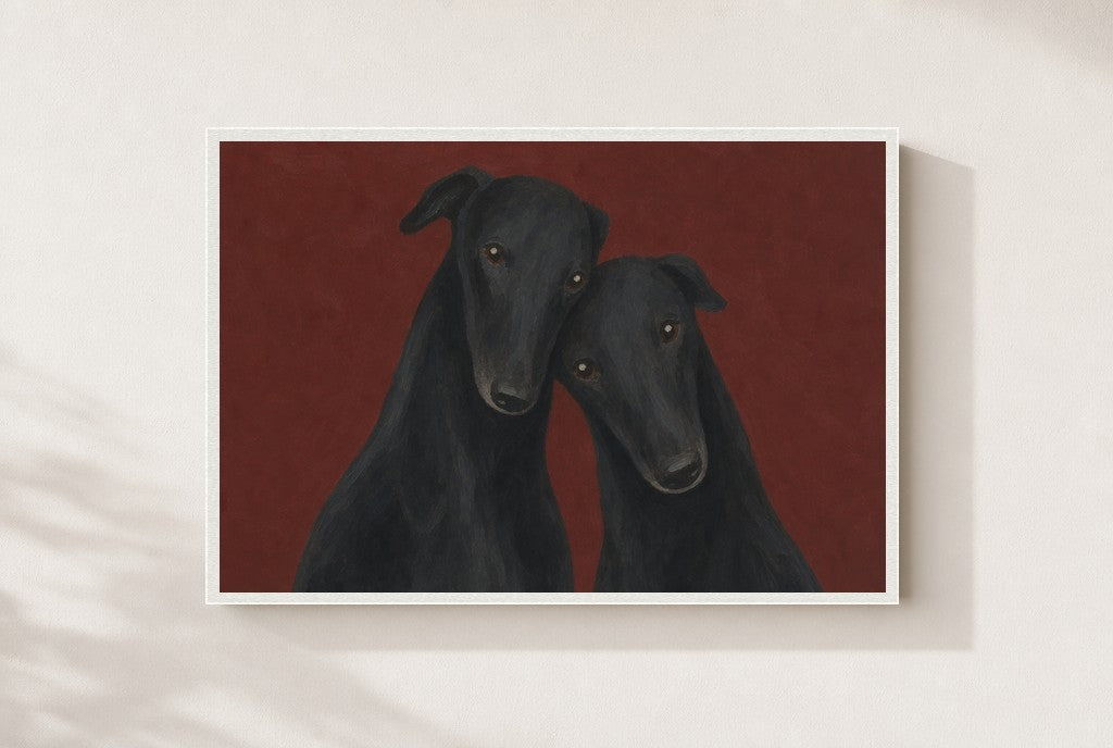 Two Greyhounds, Oxblood print, mounted in a white wood frame on a cream wall.