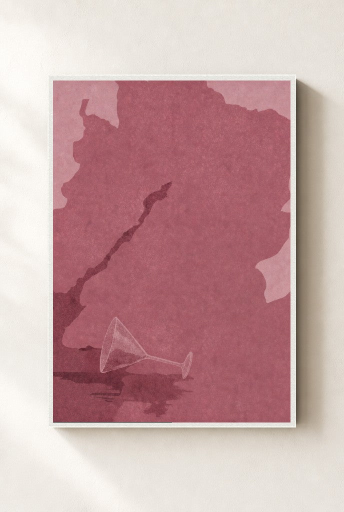 Spilled Martini, Oxblood print, mounted in a white wood frame on a cream wall.
