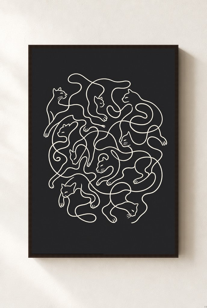 Tangled Cats print, mounted in a walnut wood frame on a cream wall.