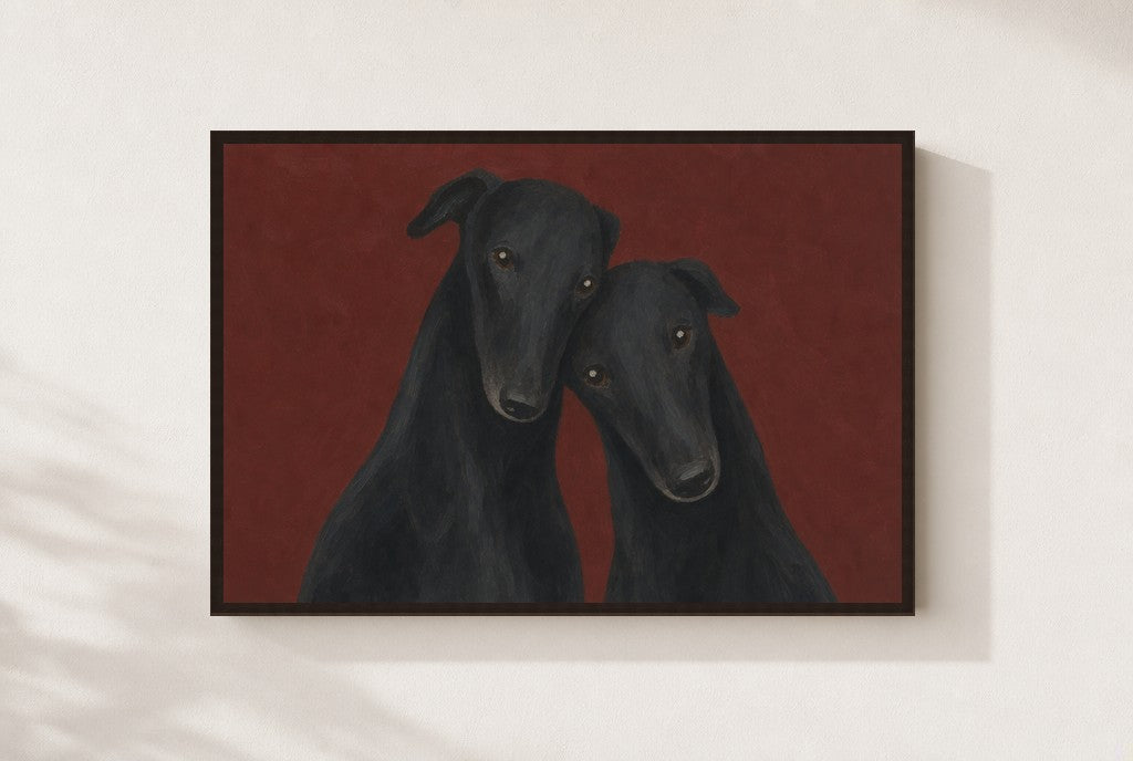 Two Greyhounds, Oxblood print, mounted in a walnut wood frame on a cream wall.
