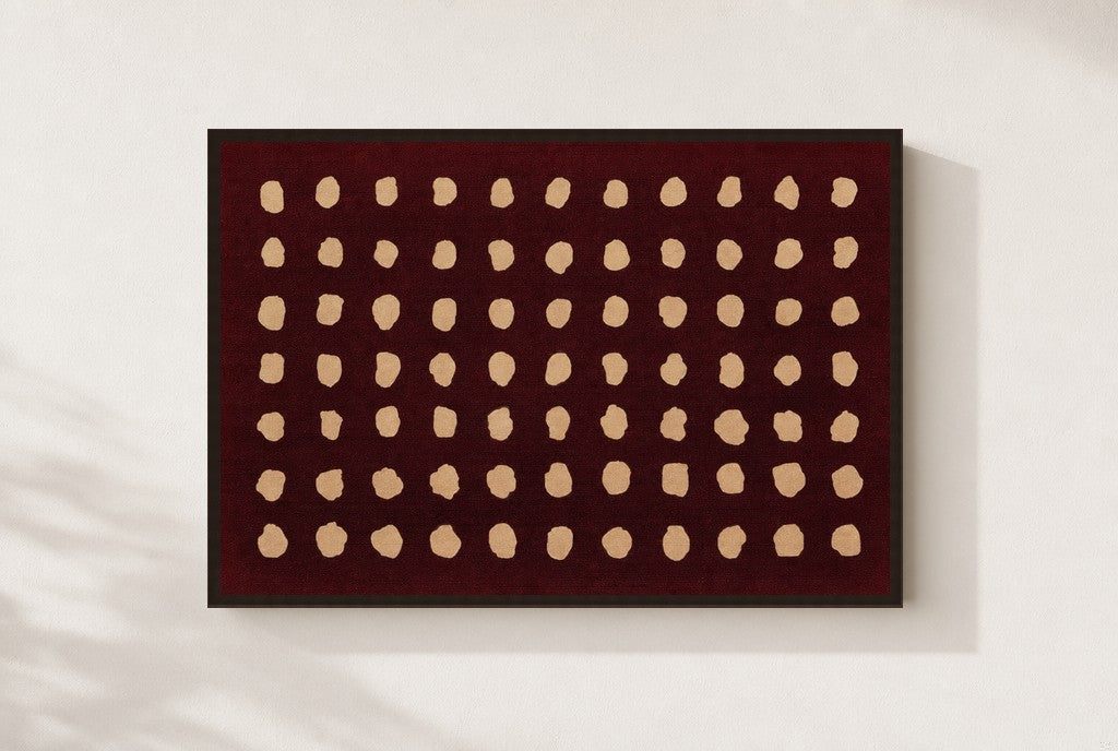 Cream Dots, Oxblood print, mounted in a walnut wood frame on a cream wall.