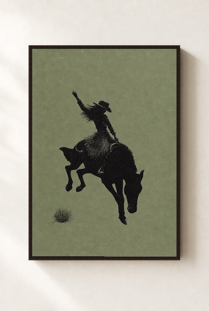 Bronc Rider, Sage print, mounted in a walnut wood frame on a cream wall.