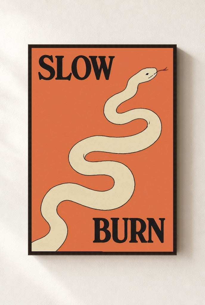Slow Burn print, mounted in a walnut wood frame on a cream wall.