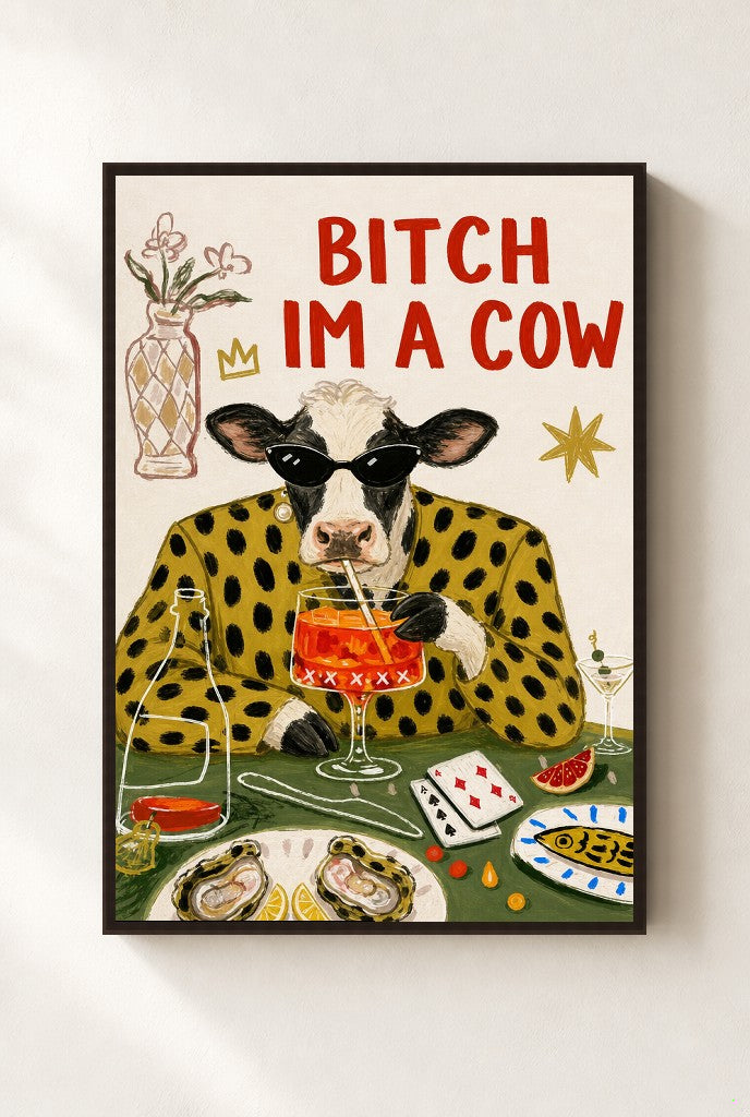 Bitch I'm a Cow print, mounted in a walnut wood frame on a cream wall.